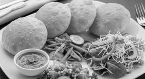 "4 poori + veg + chutney + salad "