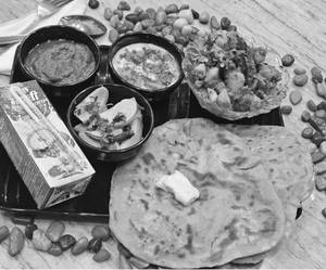 Spicy jeera aaloo with two butter paratha's and buttermilk