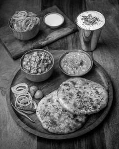 Amitsari Kulcha Served With Chole + Raita
