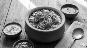 Chicken Dum Biryani(served With Raita And Gravy)