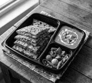 1Pcs Pyaj Paratha   + gravy+ Achar (Box Packing)