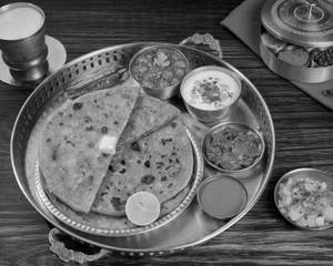 Tawa Aloo Paratha With Chole,Pickle & Raita