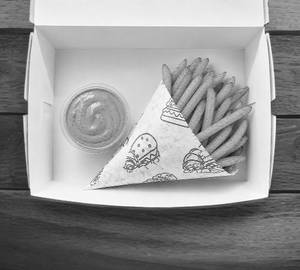 A Box Of Fries With Peri Peri Dip