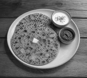 2 desi ghee aloo-pyaz paratha served with chutney and salad.