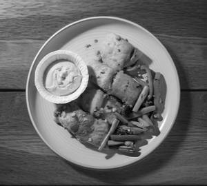 Grilled fish with sauteed vegetables and hummus