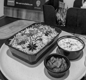 Half Kg Chicken Biryani And 100 Ml Raita.