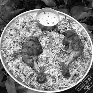 Special Tandoori Chicken Biryani(served With Raita And Gravy)