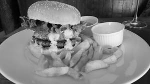 Half Pounder Lamb Burger Topped With Gherkins And Iceberg Lettuce