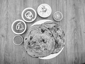 Laccha Paratha Thali(Dal Makhani + Shahi Paneer + Raita + Salad)