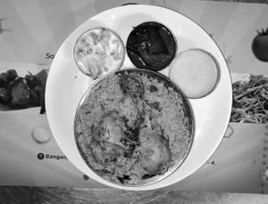 Chicken Biryani (Nawabi Style)( served with sweet,raitha & oil brinjal)